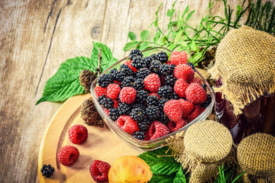 Close-up of berry fruits with vegetables on table
