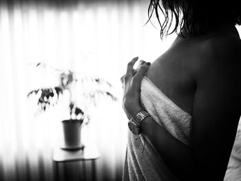 Rear view of woman standing at home