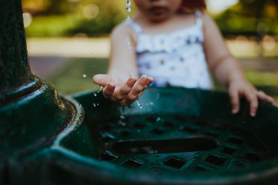 Midsection of baby girl washing hands in sink