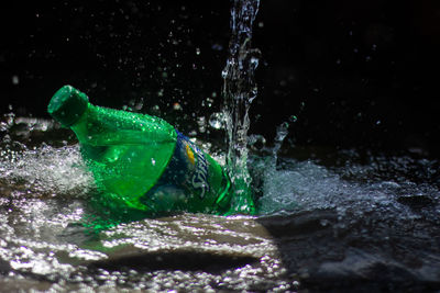 Close-up of water splashing on glass