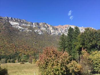 Scenic view of mountains against clear blue sky