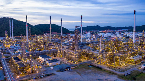 High angle view of illuminated cityscape against sky at dusk