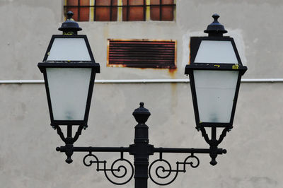 Low angle view of street light against building