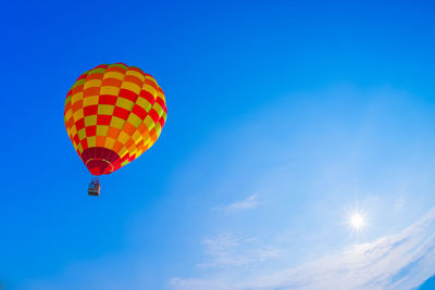 Low angle view of hot air balloon against blue sky