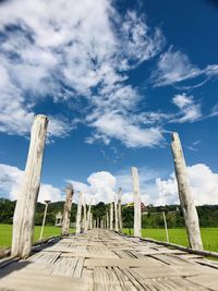 Wooden fence on landscape against sky