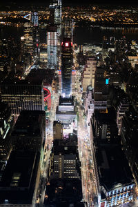 Aerial view of illuminated buildings in city at night