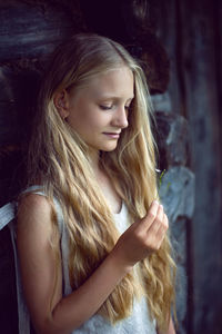 Portrait of a beautiful village girl blonde with long hair in a dress