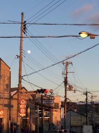 Low angle view of power lines against sky