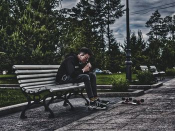 Man sitting on bench in park