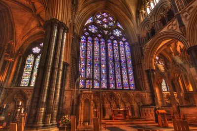 Low angle view of ornate glass window in building