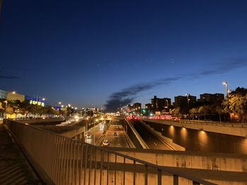 Illuminated buildings against sky at night