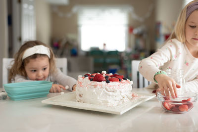 Portrait of a girl with ice cream on table