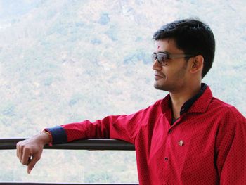 Young man standing against himalayas