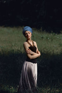 Young woman standing in grass