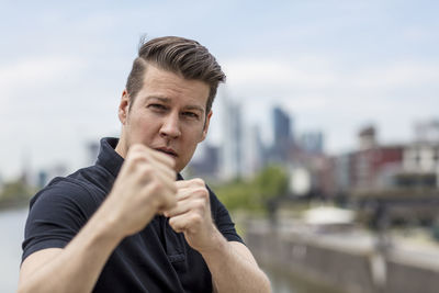 Portrait of young man in fighting stance