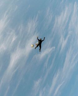 Low angle view of jumping flying against sky