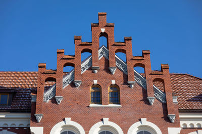 Low angle view of building against clear blue sky