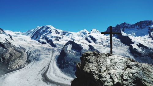 Scenic view of snowcapped mountains against clear blue sky