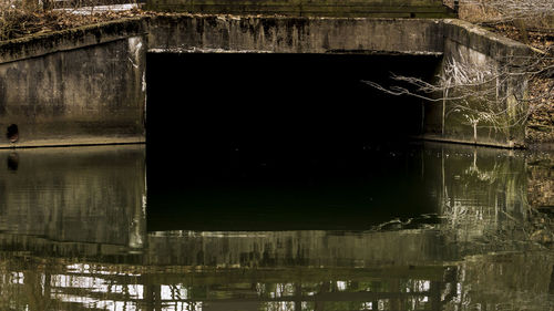 Reflection of old building in lake at night