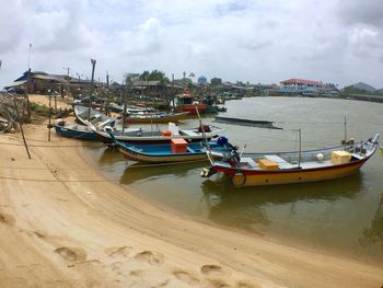 Boats moored at harbor