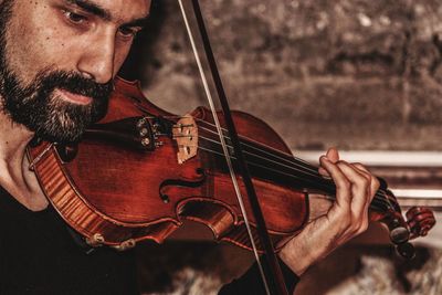 Close-up of man playing violin