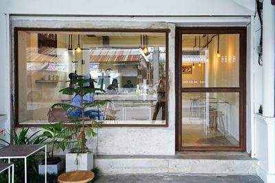 Exterior design and decoration of coffee cafe decorated with wooden furniture and mirror glass frame