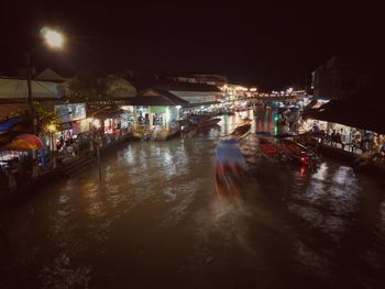 People on illuminated city at night