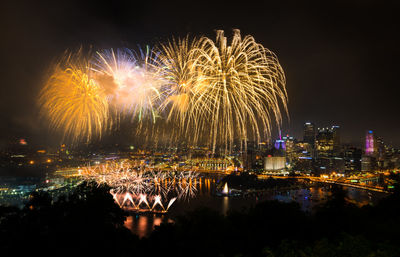 Firework display over city at night