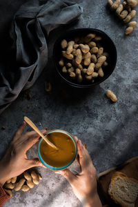 High angle view of hand holding food on table