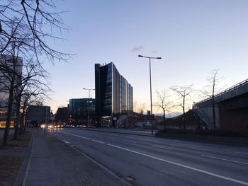 City street and buildings against sky