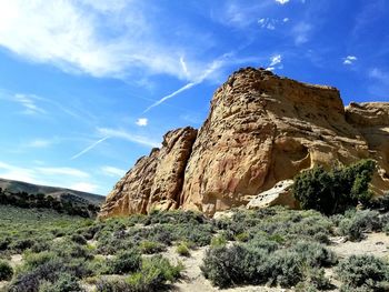 Low angle view of rock formations against sky