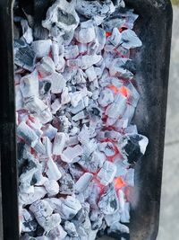 High angle view of burning candles on metal