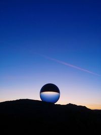 Low angle view of silhouette mountain against clear sky