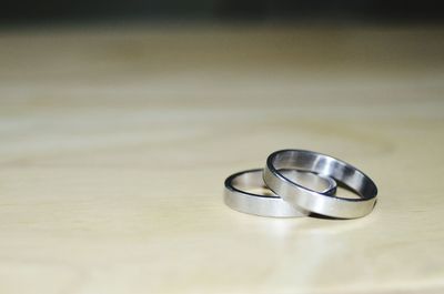 Close-up of wedding rings on table