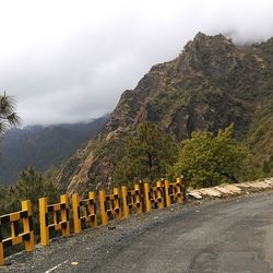 Scenic view of mountains against cloudy sky