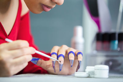Midsection of woman holding hands on table