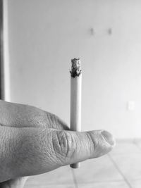 Close-up of hand holding cigarette