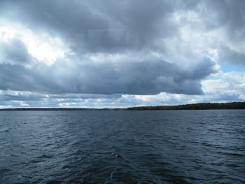 Scenic view of sea against storm clouds