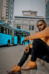 Portrait of young man exercising on street