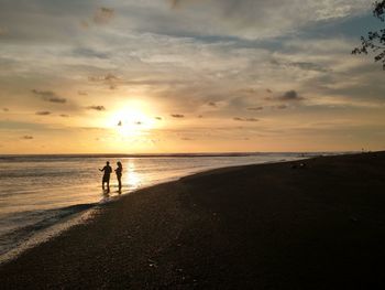 Scenic view of beach against sky during sunset