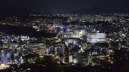 High angle view of illuminated city buildings at night