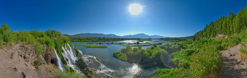 Panoramic view of sea against clear blue sky