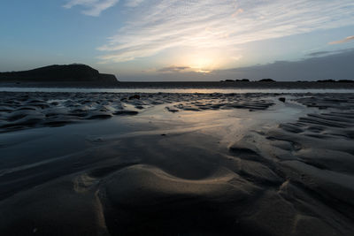 Scenic view of beach against sky during sunset