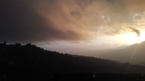 Silhouette mountains against sky during sunset