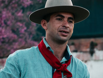 Man wearing hat standing outdoors
