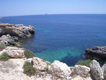 Scenic view of sea against blue sky