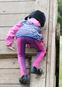 Low section of girl playing on wood