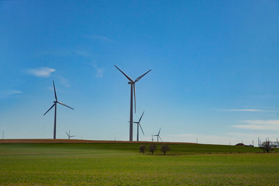 Windmill on field against sky