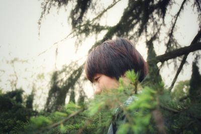 Side view of woman amidst plants