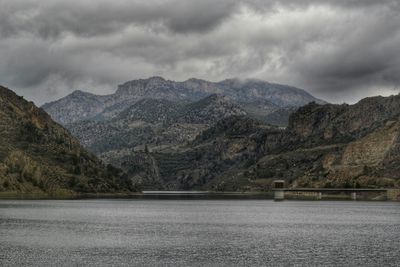 Scenic view of lake against cloudy sky